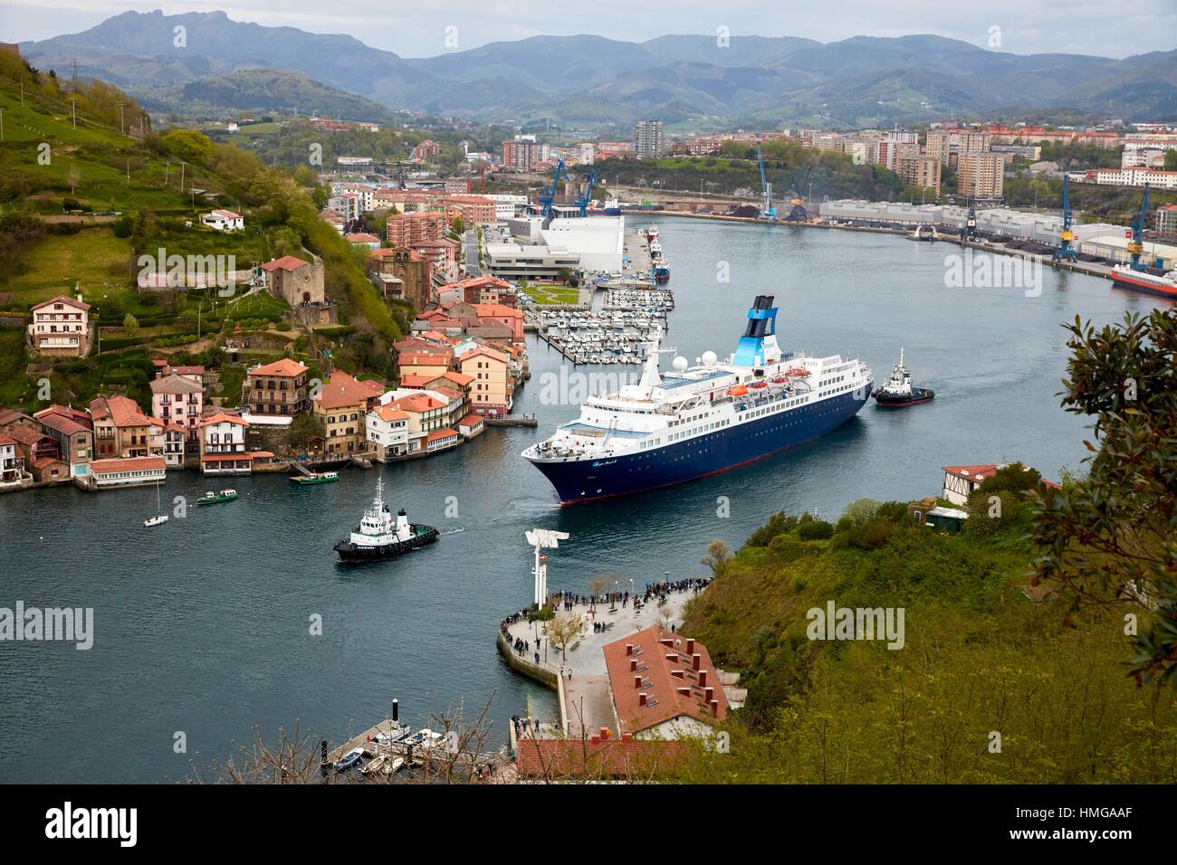 Tugboat and cruise liner. Passenger ship. Tug maneuvers. Pasaia Port. Gipuzkoa. Basque Country. Spain. Europe. Stock Photo