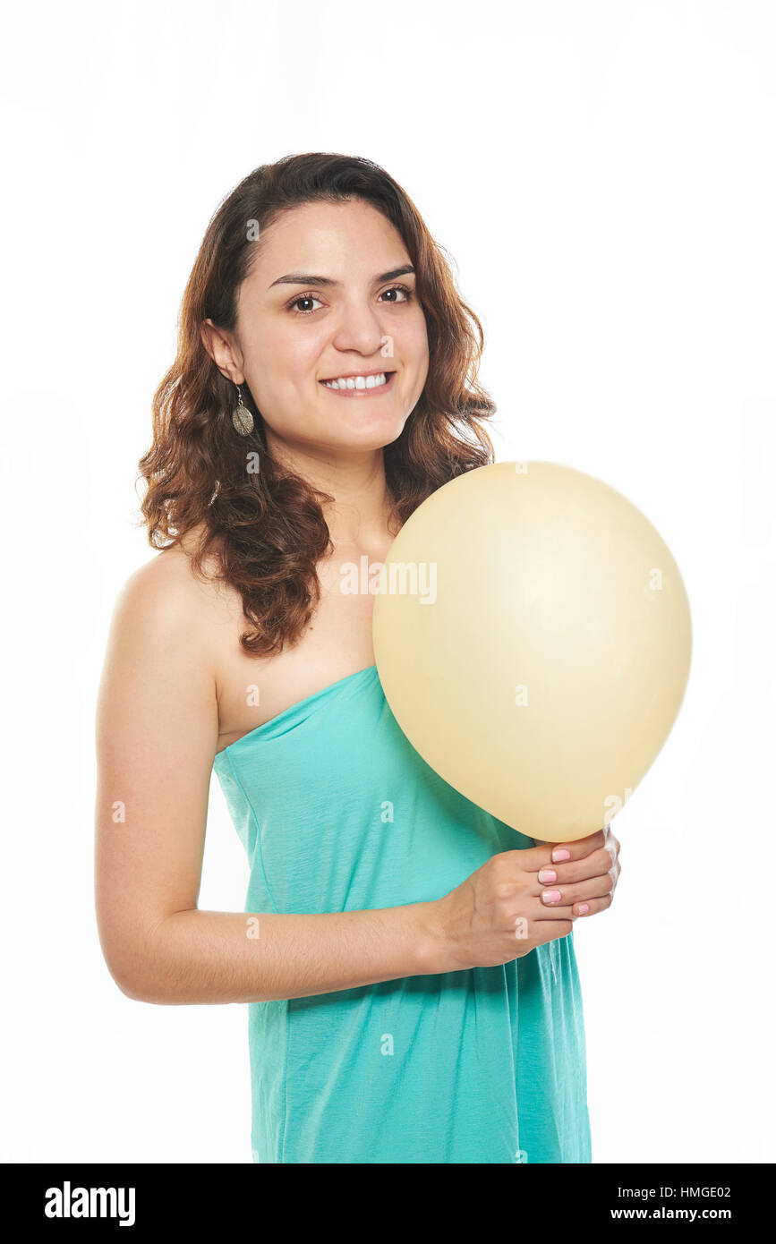 girl on aqua dress holding yellow balloon Stock Photo - Alamy
