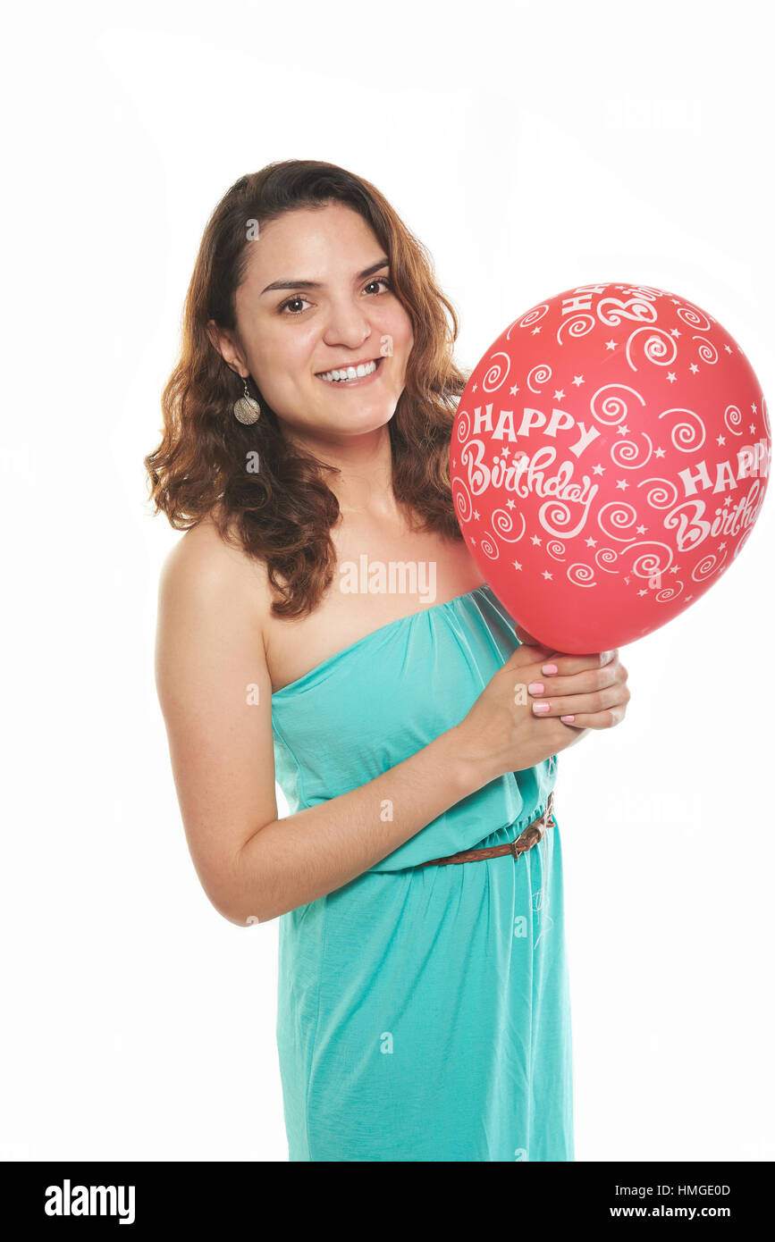 latin girl smiling with red happy birthday balloon Stock Photo