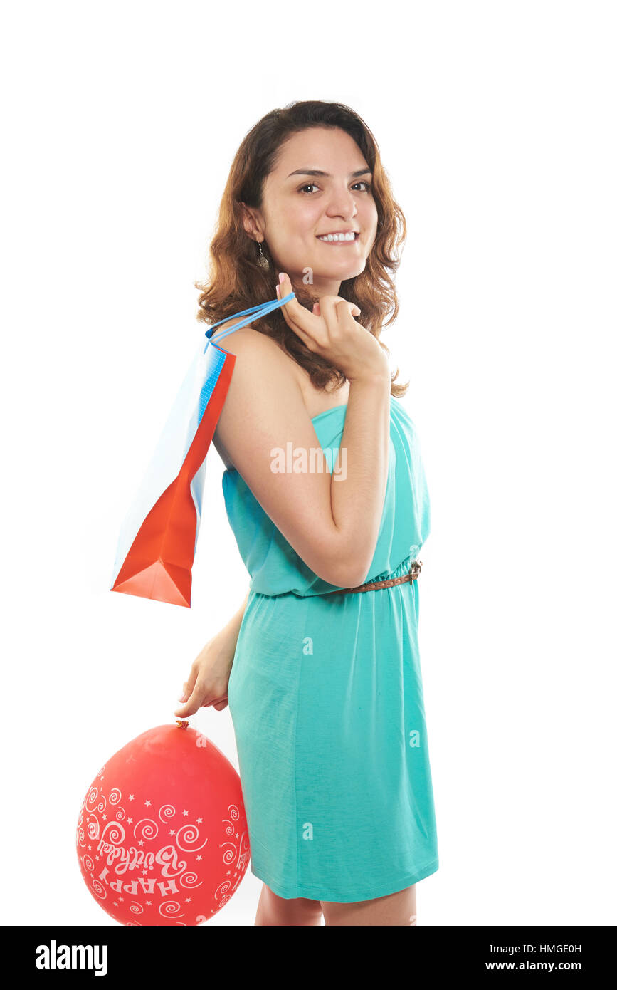 girl with birthday bag present and red balloon Stock Photo