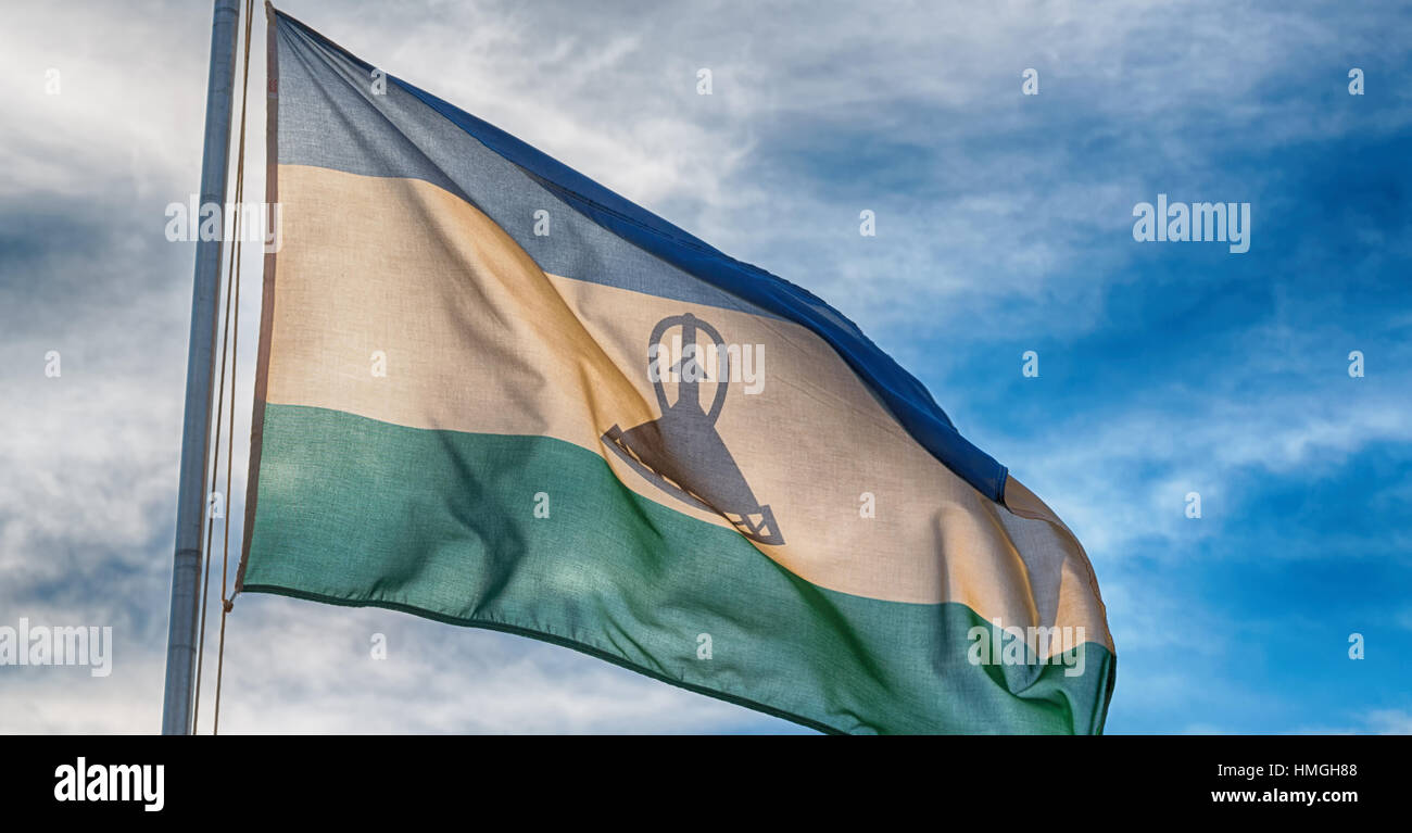 blur in lesotho waving national flag in the cloudy sky Stock Photo - Alamy