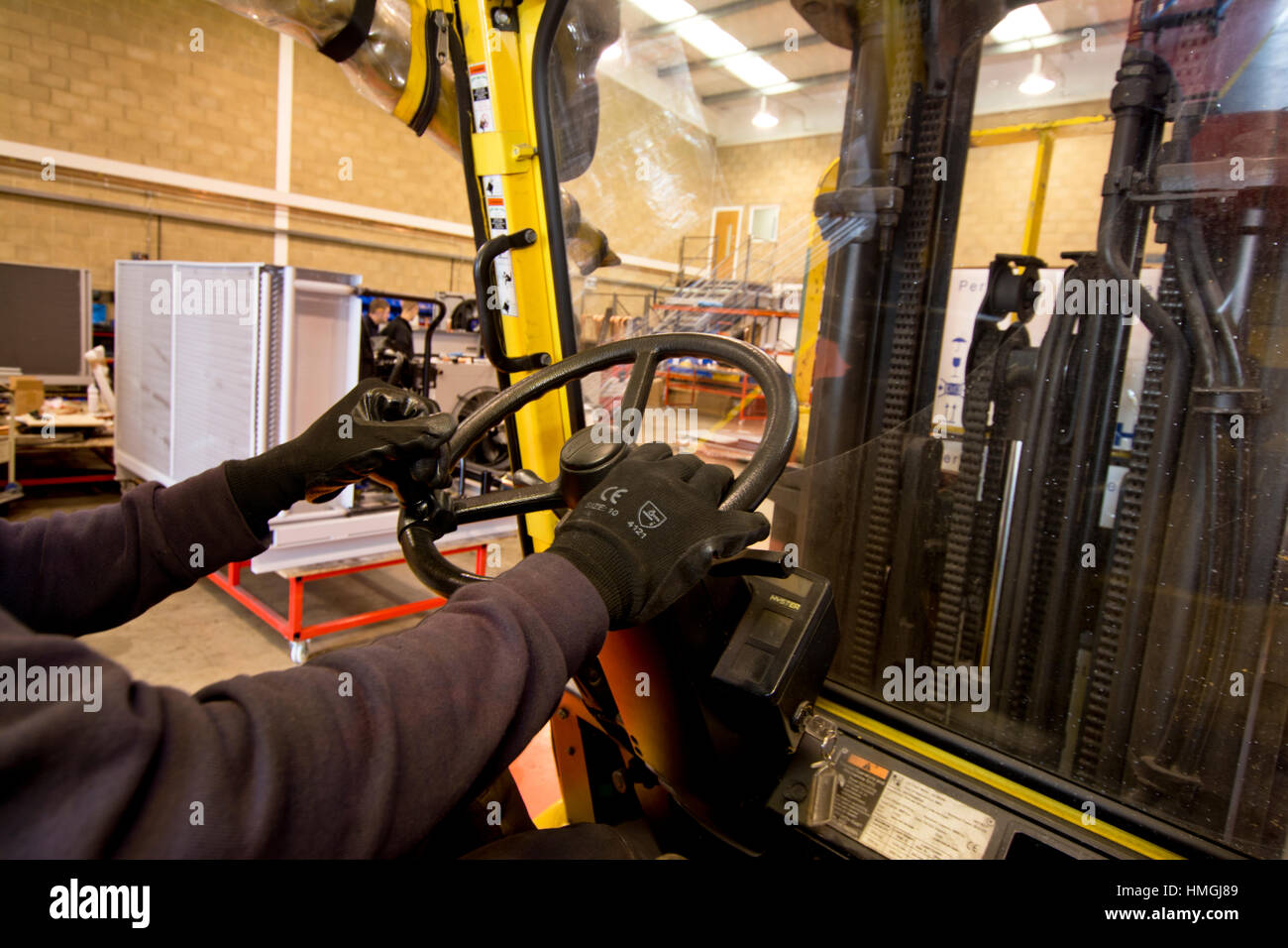 forklift truck driver iinside cab driving inside industrial engineering Stock Photo Alamy