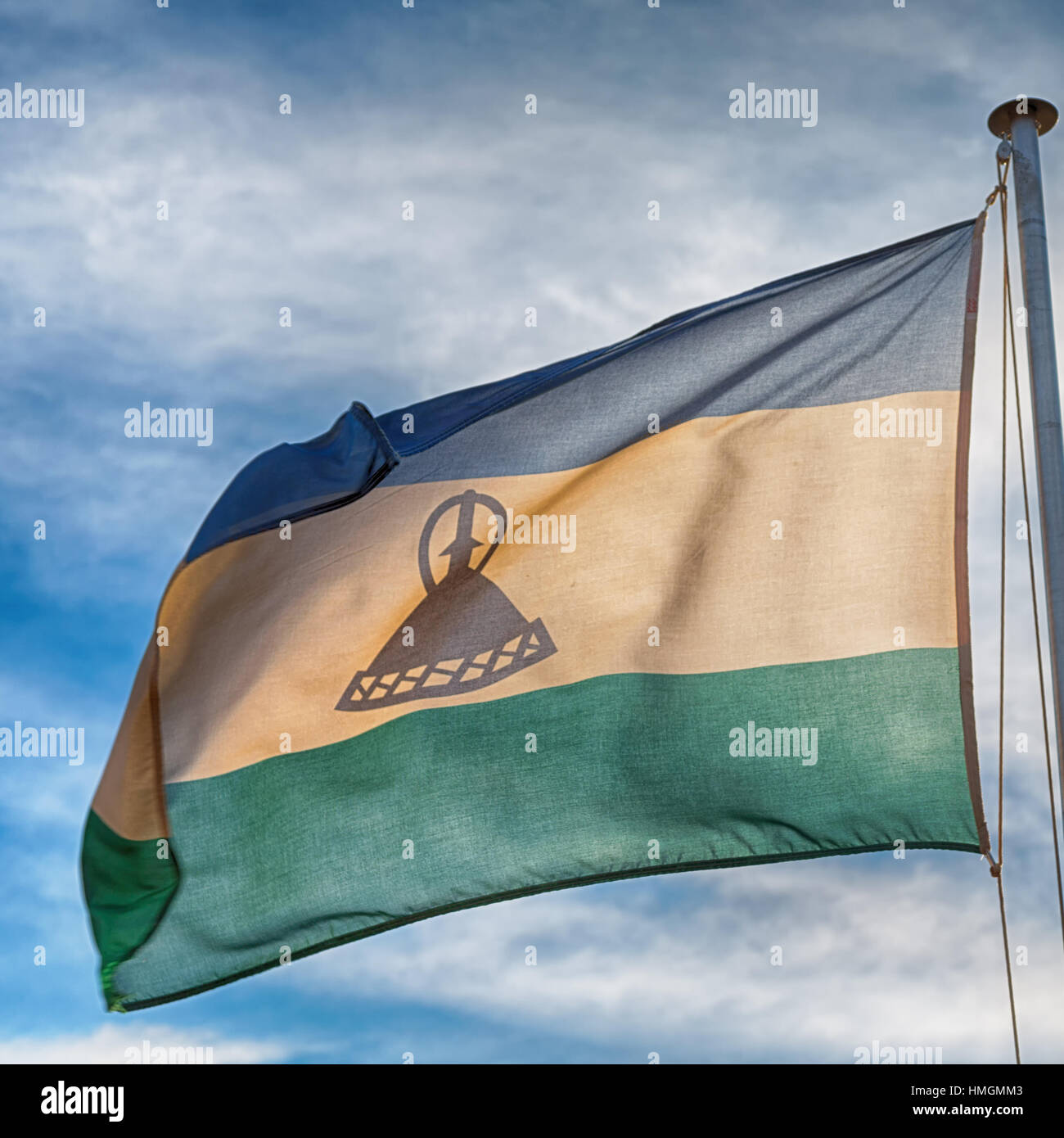 blur in lesotho waving national flag in the cloudy sky Stock Photo - Alamy