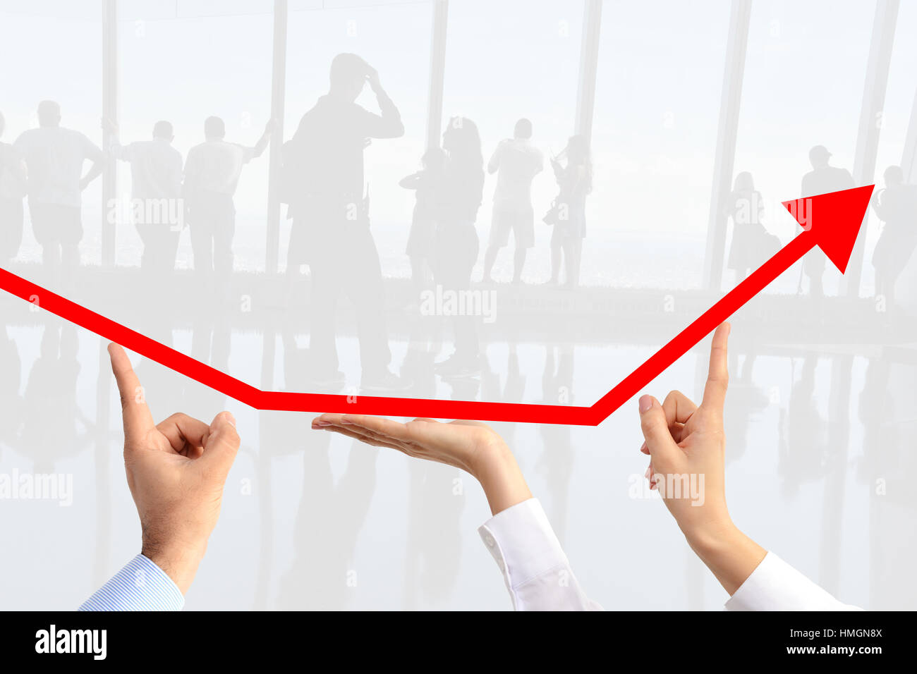 Teamwork concept with business people hands steering an arrow suggesting increase sales Stock Photo