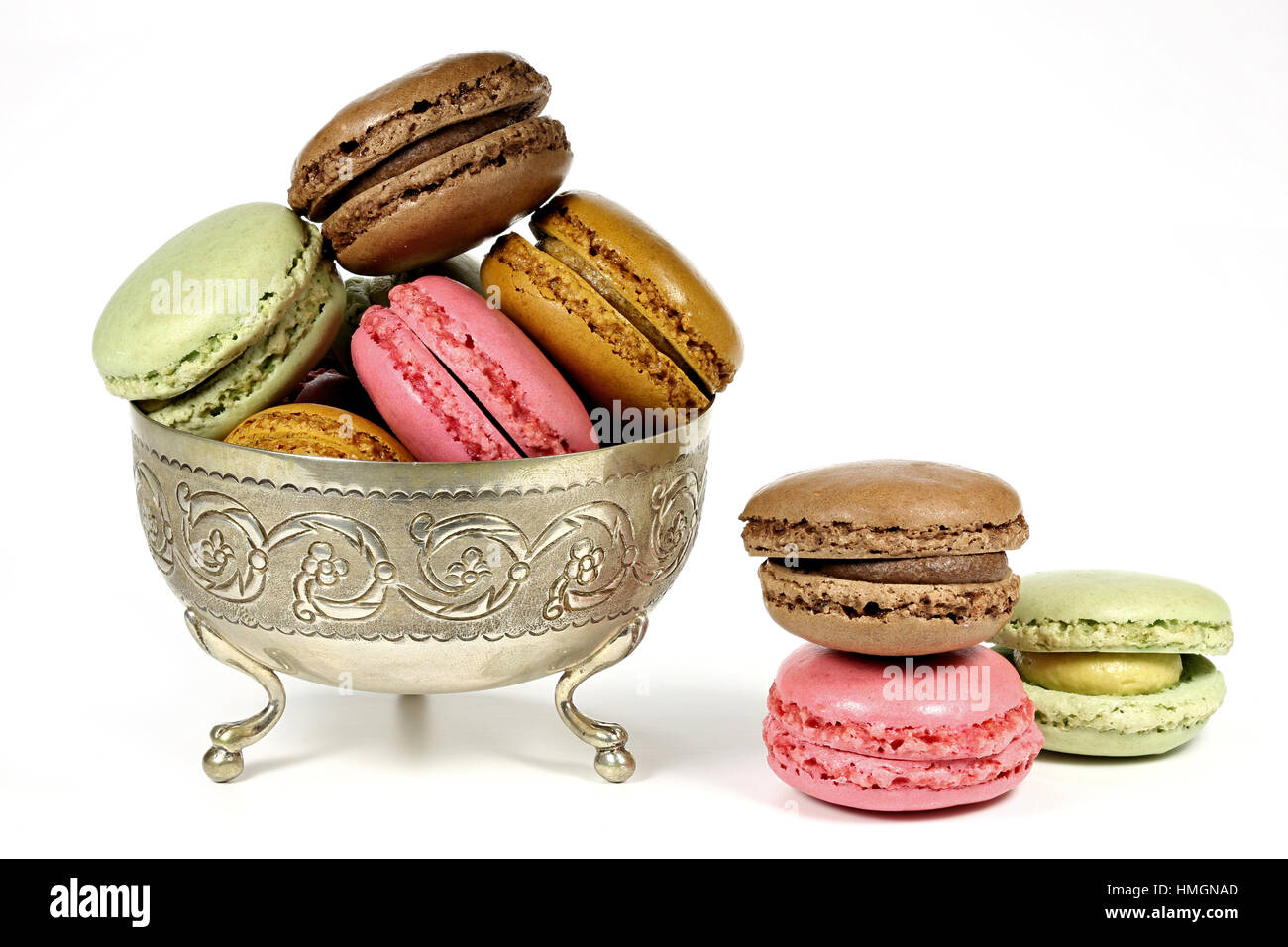 colorful macarons in a silver bowl isolated on white background Stock Photo