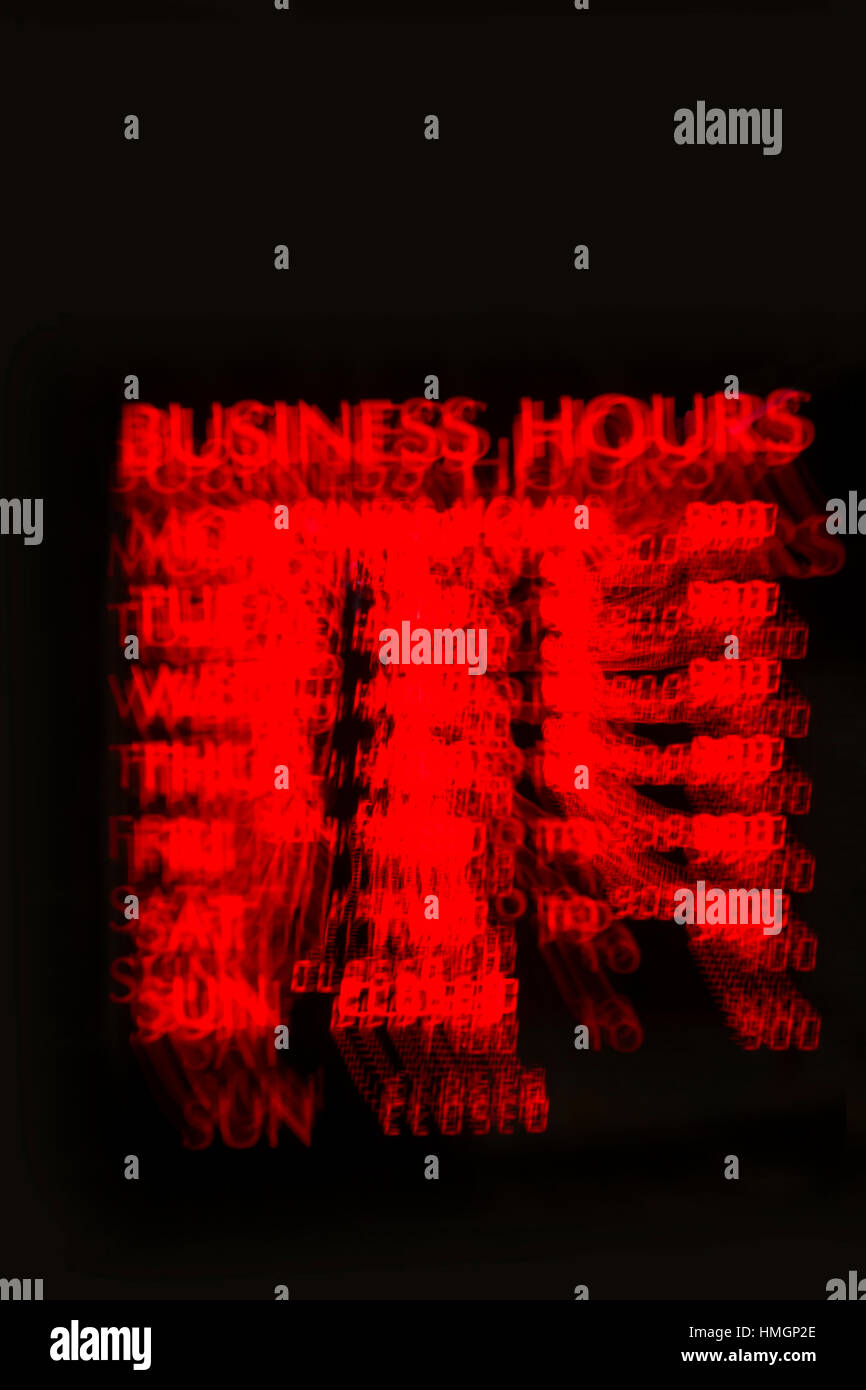 A business hours sign with a partial zoom effect. Stock Photo