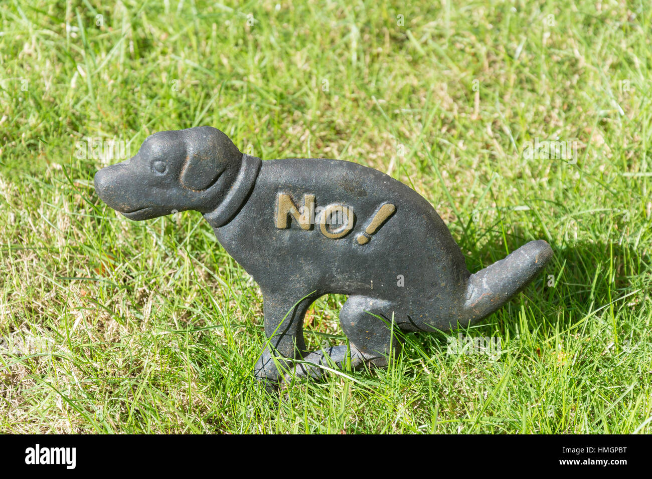 Metal 'no dog poo' sign on grass verge, Guildford Road, Westcott, Surrey, England, United Kingdom Stock Photo