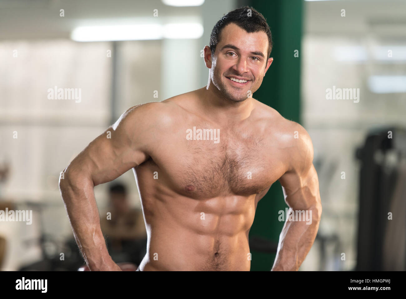 Healthy Young Man Standing Strong In The Gym And Flexing Legs close Up -  Muscular Athletic Bodybuilder Fitness Model Posing After Exercises Stock  Photo - Alamy