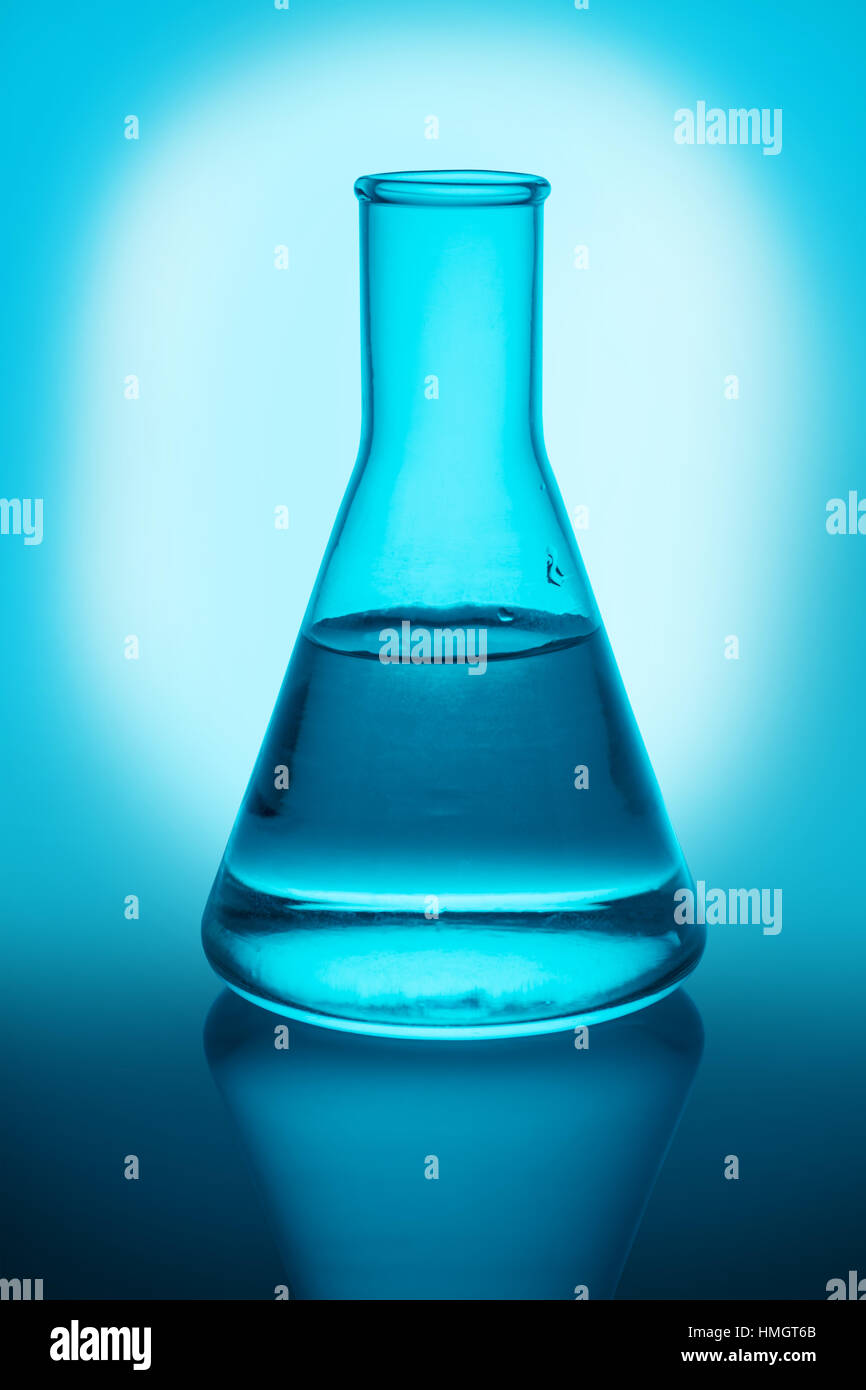 Chemical flask with liquid on blue background Stock Photo Alamy