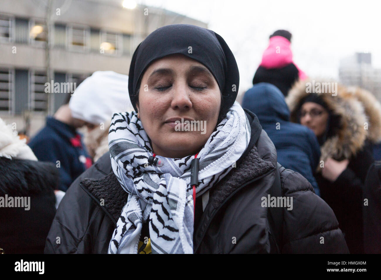 Brooklyn, New York, United States. 2nd February, 2017. Heba Omar, a Pre K- 2nd grade teacher from PS 261 in Brooklyn holds back tears as she recounts her students' confusion and sadness around President Trump's statements against Muslims. She participates in a rally with thousands of people after the “bodega strike” in front of Brooklyn Borough Hall in New York City against the Trump administration's immigration policies. Mansura Khanam/ Alamy Live News Stock Photo