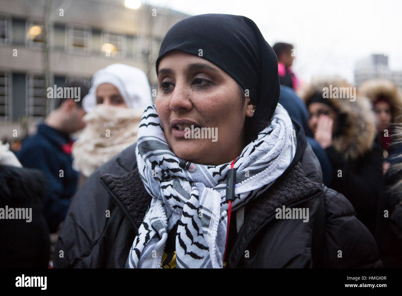 Brooklyn, New York, United States. 2nd February, 2017. Heba Omar, a Pre K- 2nd grade teacher from PS 261 in Brooklyn holds back tears as she recounts her students' confusion and sadness around President Trump's statements against Muslims. She participates in a rally with thousands of people after the “bodega strike” in front of Brooklyn Borough Hall in New York City against the Trump administration's immigration policies. Mansura Khanam/ Alamy Live News Stock Photo