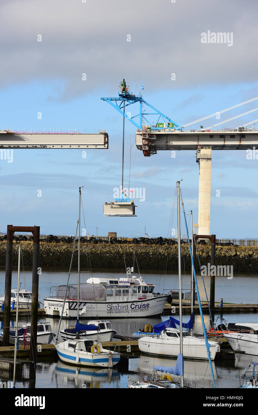Edinburgh, Scotland, United Kingdom. 3rd February, 2017. Flags of many nations who had a part in the contract for construction of the new Queensferry Crossing road bridge across the Forth Estuary fly from the last deck section as it is lifted into place to complete the span, Credit: Ken Jack/Alamy Live News Stock Photo