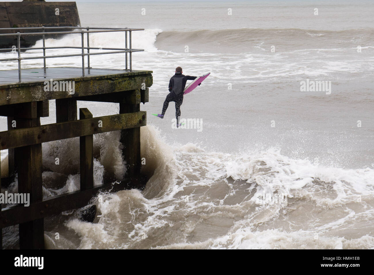 Aberystwyth, Ceredigion, Wales, UK. 3rd Feb, 2017. UK Weather. High tides and a strong Atlantic swell this morning bring huge waves crashing into the promenade and sea defences in Aberystwyth on the west wales coast. A brave body-boarder takes the opportunity of riding some of the huge 10' high waves as they break near Aberystwyth harbour Potentially damaging gales, with gusts in excess of 60mph are forecast to strike parts of southern UK today photo Credit: Keith Morris/Alamy Live News Stock Photo