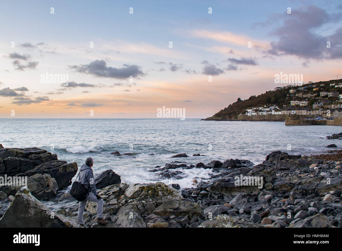 Mousehole , Cornwall, UK. 4th Feb 2017. UK Weather. After 2 days of storms and ferocious seas a calm start to the day at Mousehole looking out to Mounts Bay. Fishing boats are finally able to head back to sea again. Credit: Simon Maycock/Alamy Live News Stock Photo