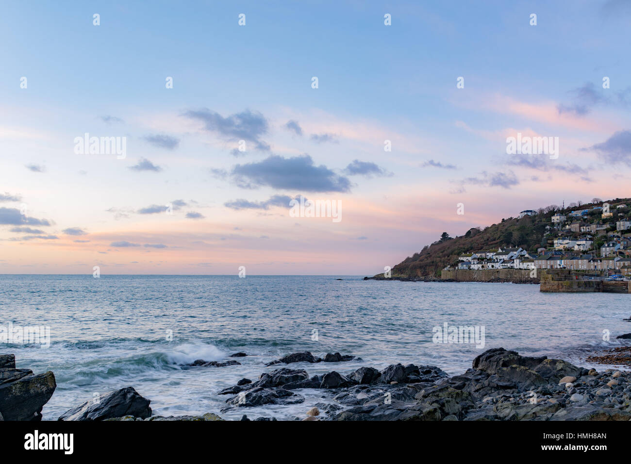 Mousehole , Cornwall, UK. 4th Feb 2017. UK Weather. After 2 days of storms and ferocious seas a calm start to the day at Mousehole looking out to Mounts Bay. Fishing boats are finally able to head back to sea again. Credit: Simon Maycock/Alamy Live News Stock Photo
