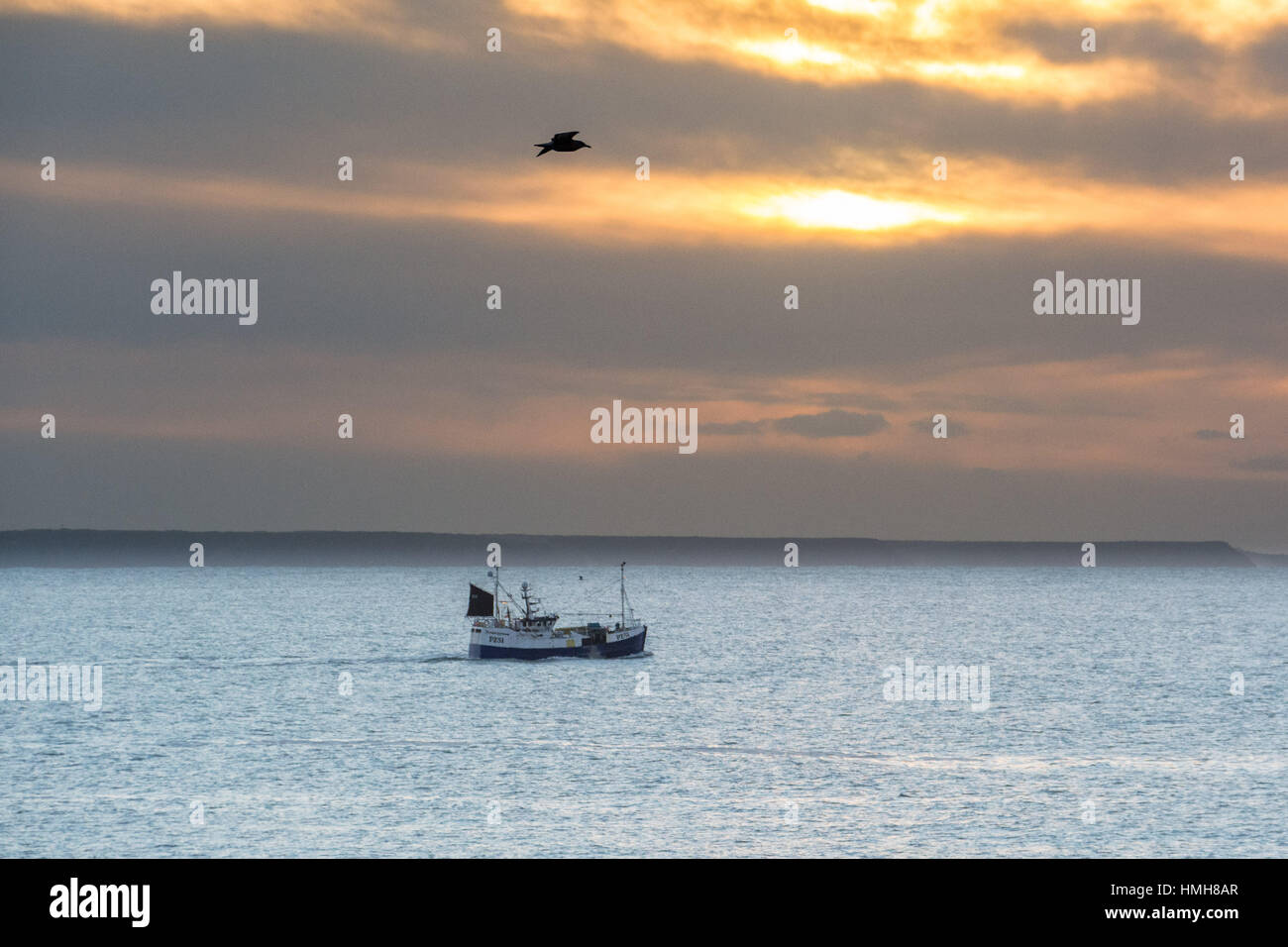Mousehole , Cornwall, UK. 4th Feb 2017. UK Weather. After 2 days of storms and ferocious seas a calm start to the day at Mousehole looking out to Mounts Bay. Fishing boats are finally able to head back to sea again. Credit: Simon Maycock/Alamy Live News Stock Photo