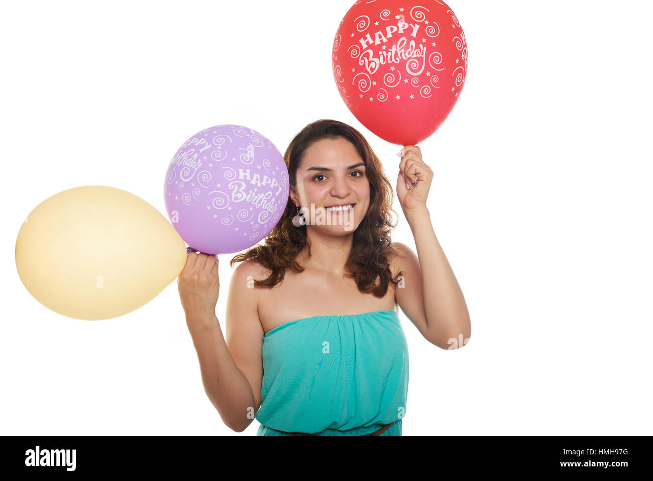 Girl holding yellow and red happy birthday balloons Stock Photo