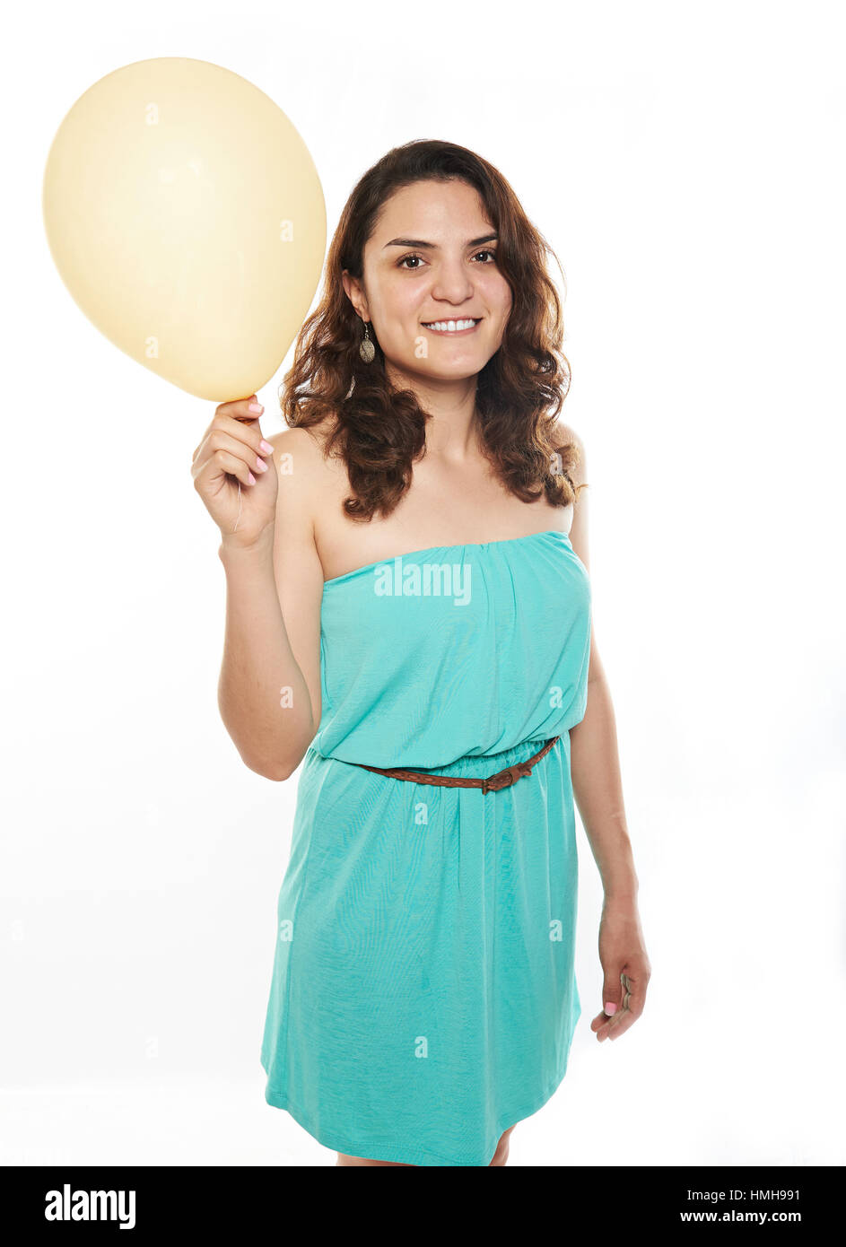 latino girl with yellow balloon isolated on white Stock Photo