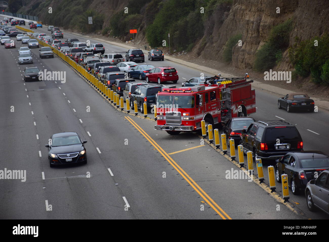 LA Fire Engine Plow Through Heavy Traffic and Turn Around to Switch Lane and Direction near a Cliff Stock Photo