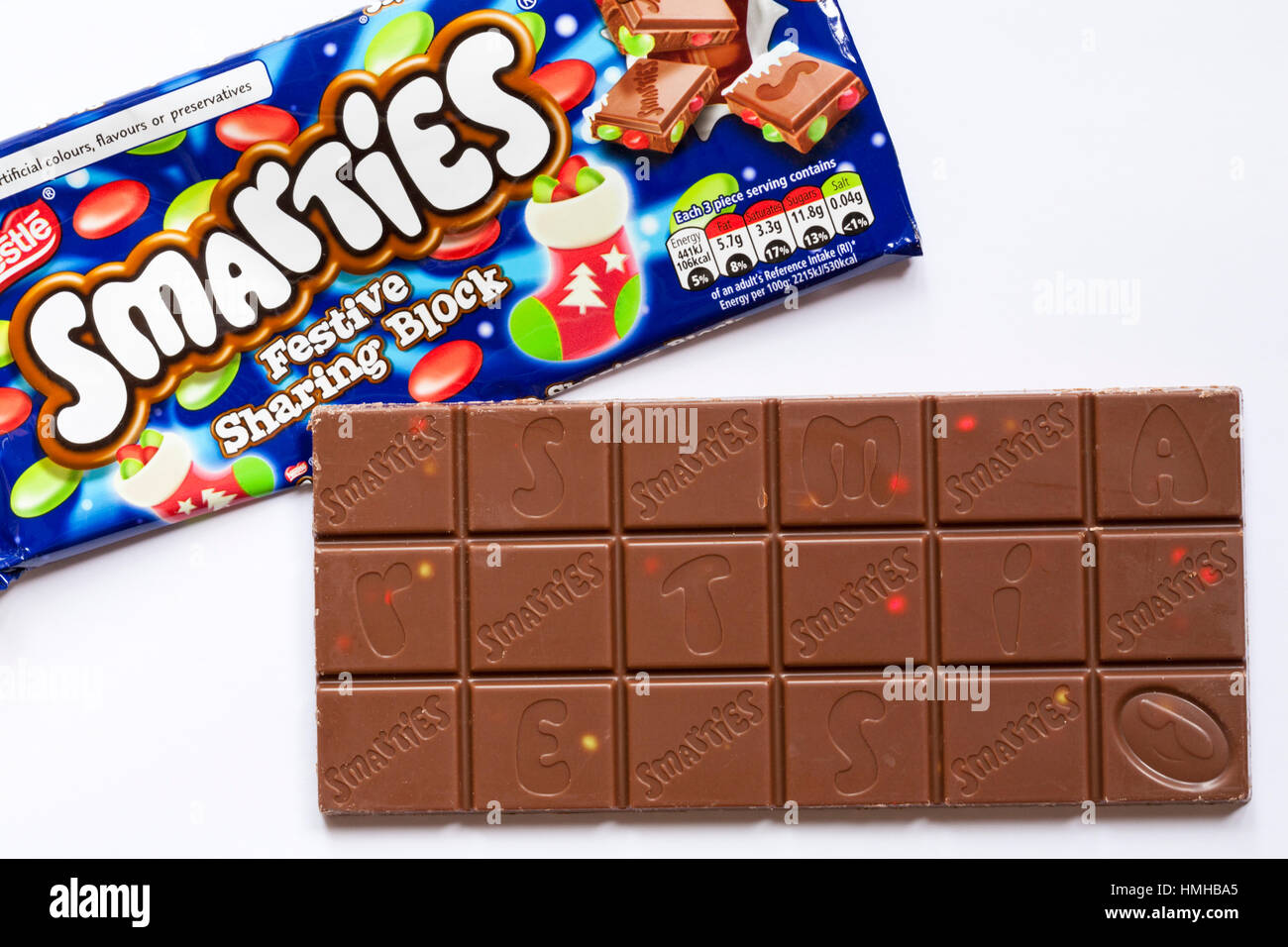 Bar of Nestle Smarties Festive Sharing Block of chocolate out of wrapper to show contents set on white background - showing chocolate squares Stock Photo