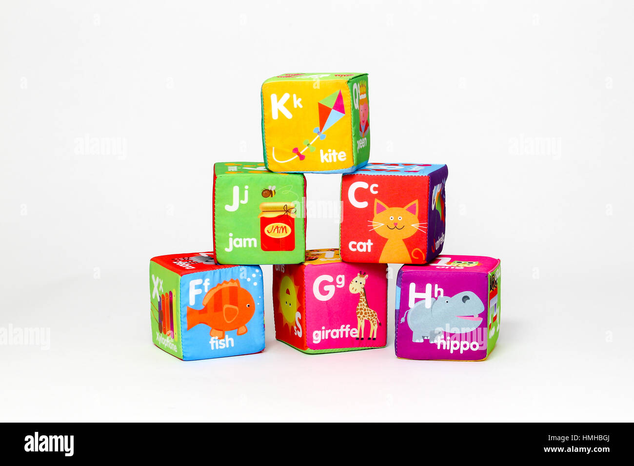Children's toy coloured building blocks against a white background ...