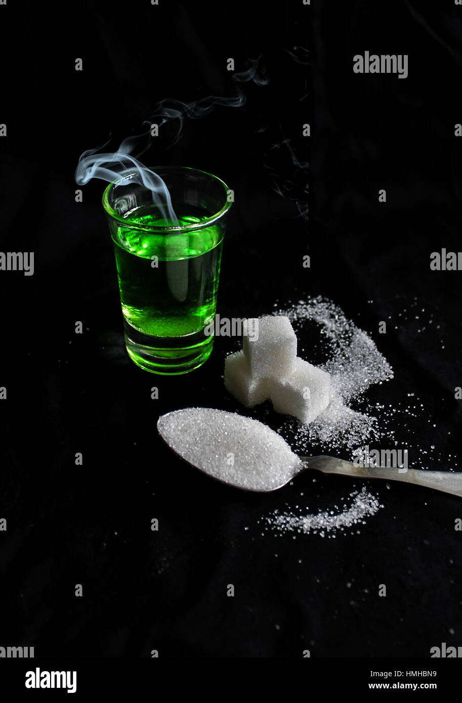 absinthe with sugar cubes and spoon flat lay composition Stock Photo