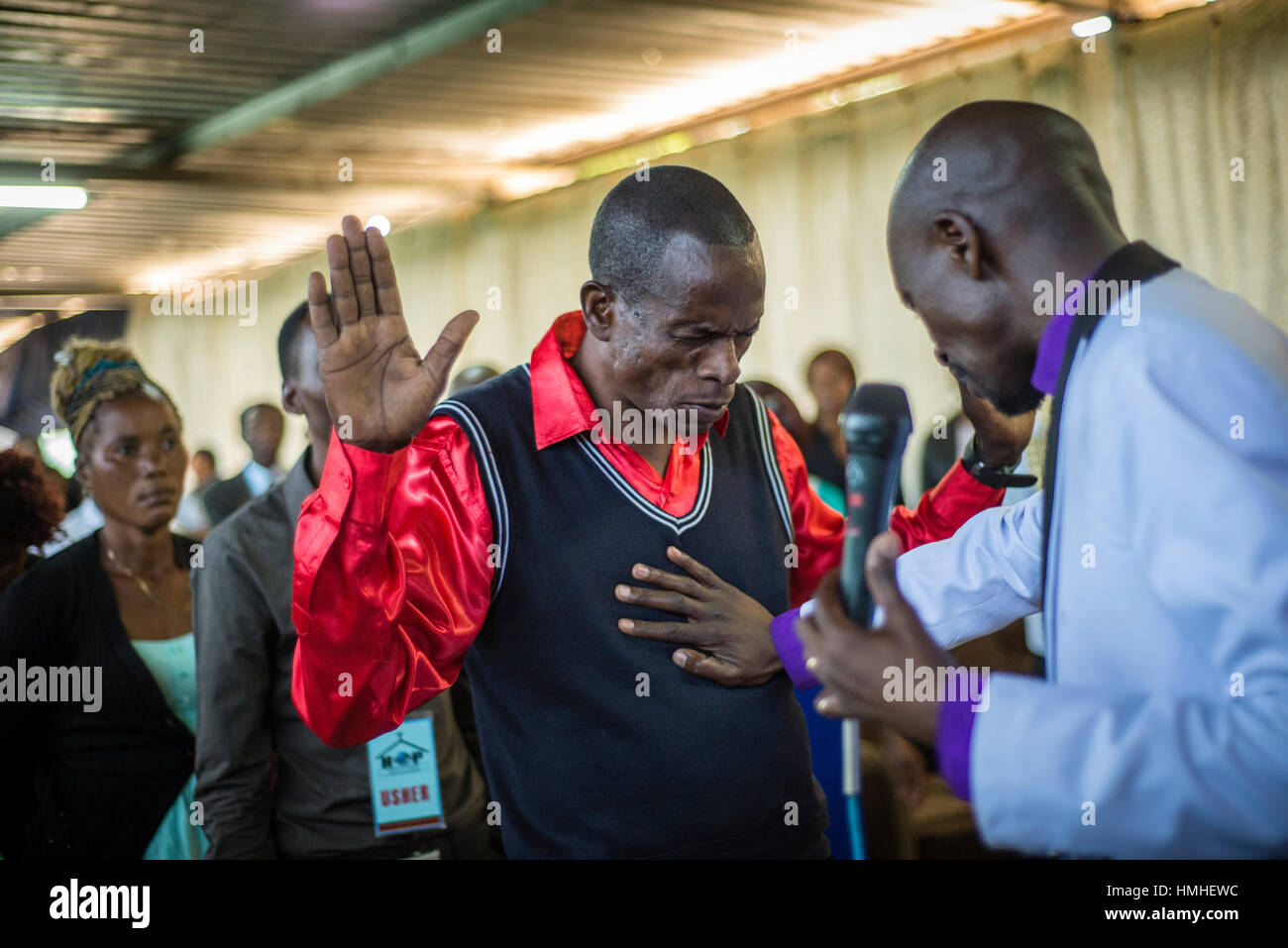 Pastor Chibwe Katebe exorcises the evil spirit from the body of a man during a Sunday service at the House of Prayer for All Nations in Livingstone, Zambia Stock Photo