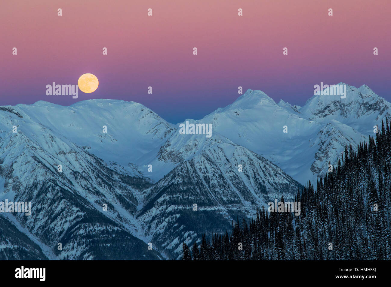 Full moon rising over Canadian Rockies; viewed from Esplanada Range