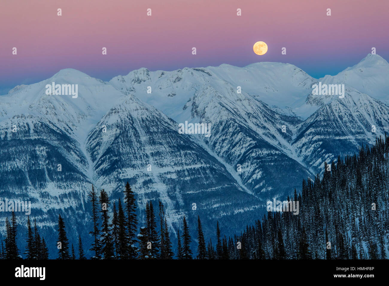 Full moon rising over Canadian Rockies; viewed from Esplanada Range
