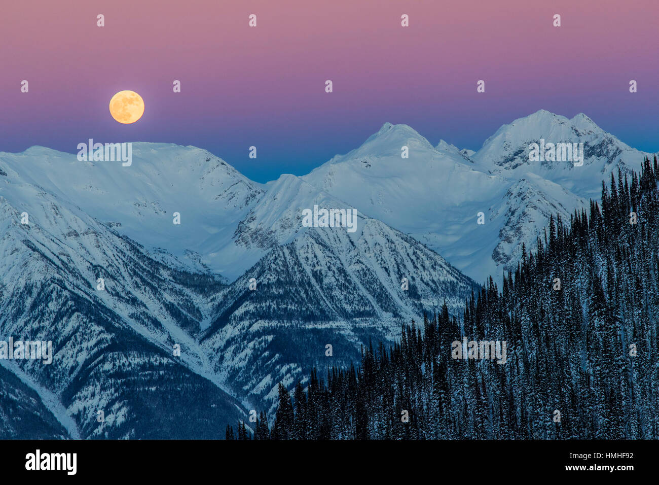 Full moon rising over Canadian Rockies; viewed from Esplanada Range