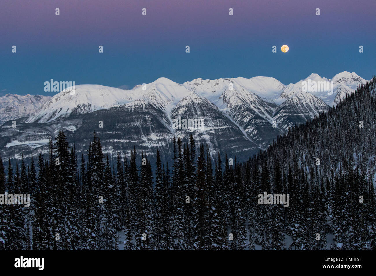 Full moon rising over Canadian Rockies; viewed from Esplanada Range