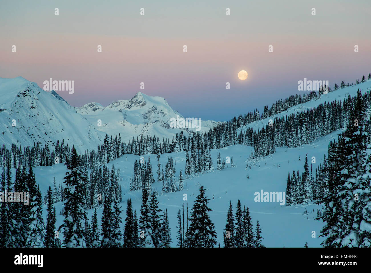 Full moon setting over Canadian Rockies; viewed from Esplanada Range