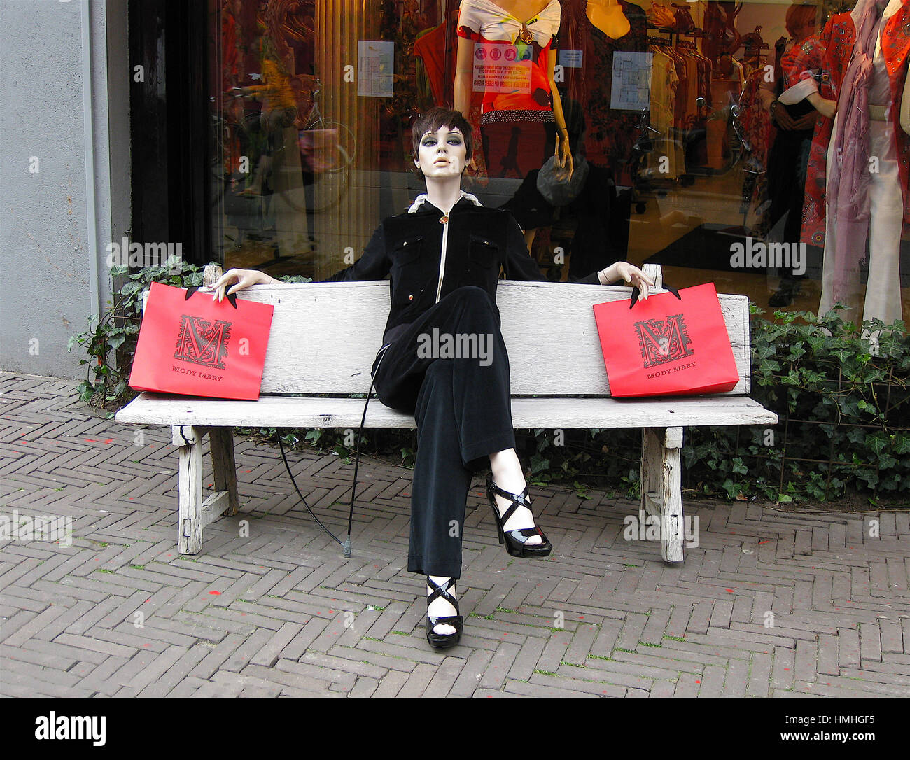 Mannequin sitting on a bench outside a shop in Amsterdam, The