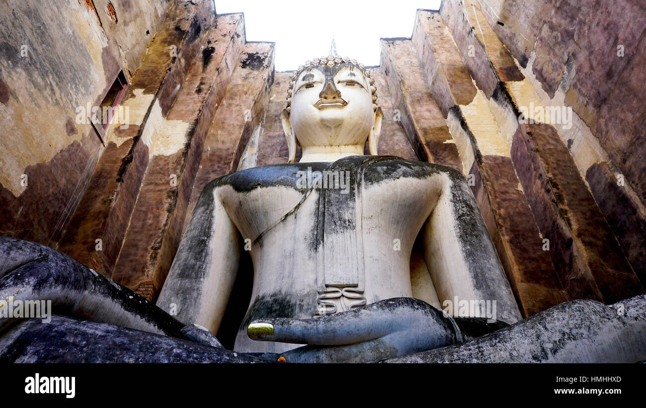 Historical Park Wat Sri chum temple bhudda statue worm eye view in Sukhothai world heritage Stock Photo