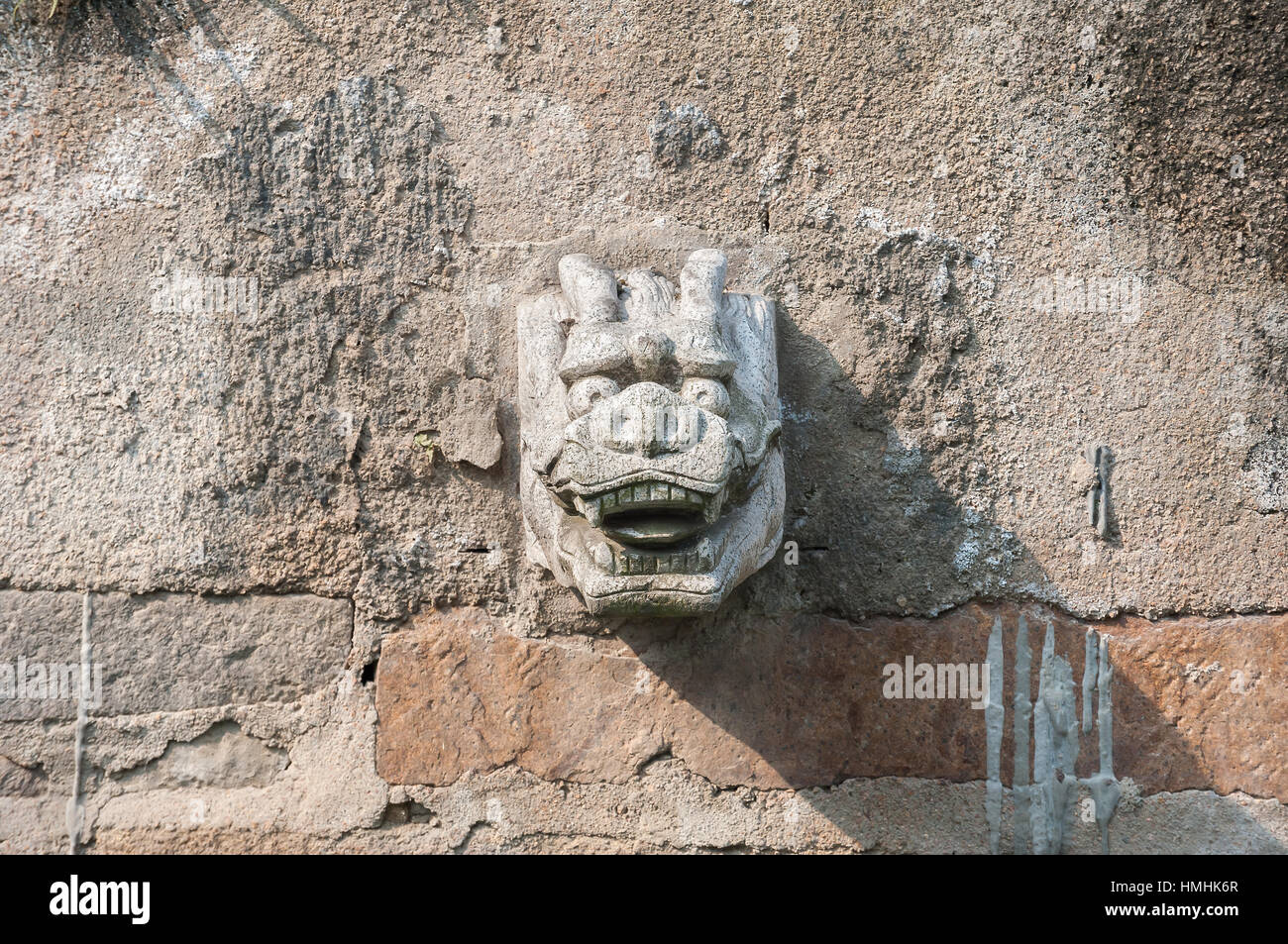 Stone dragon head water spout on a Suzhou canal, China Stock Photo
