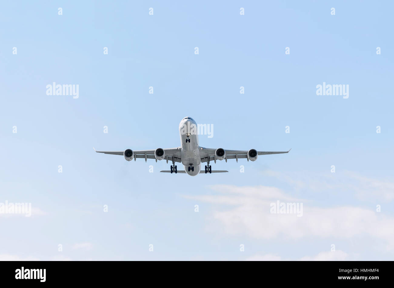 Airplane Airbus A340, of Iberia airline. Blue sky with some clouds. Stock Photo