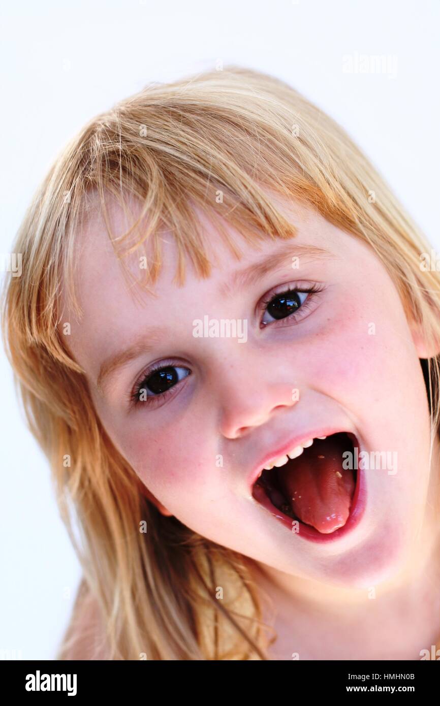 Blonde 4 year old child, with long hair, happy messing funny face ...