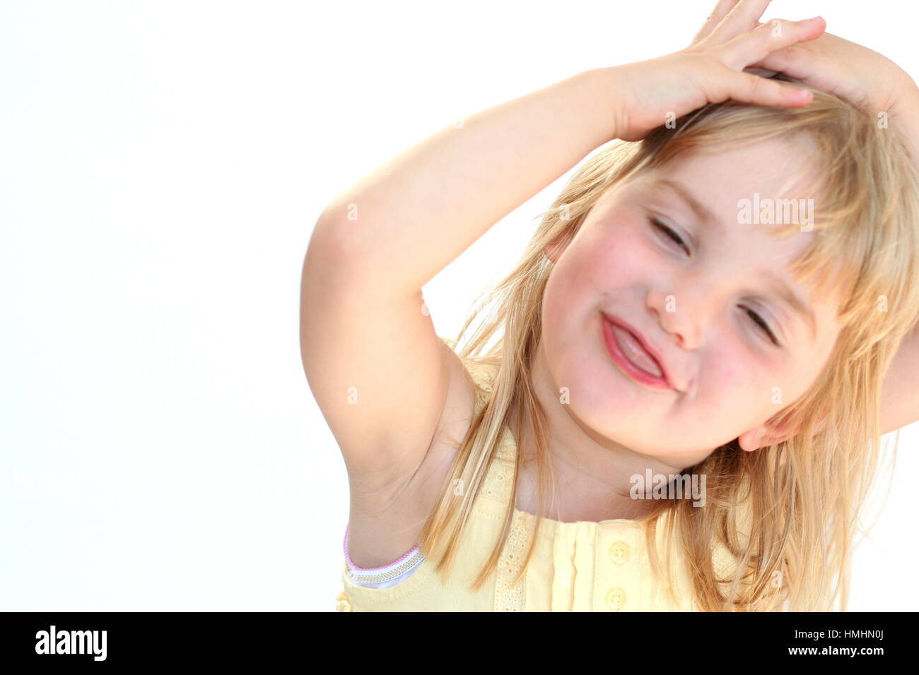 young girl smiling / child making a funny face sticking tongue out Stock Photo