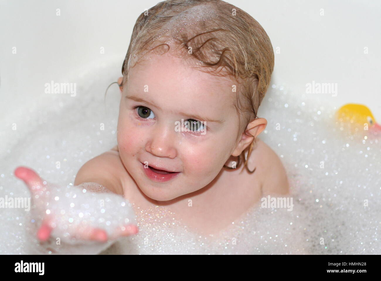Little baby girl / toddler child kid sitting bubble bath wet hair