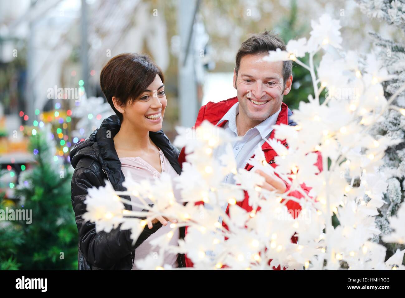 Couple buying Christmas tree, garden center Stock Photo Alamy