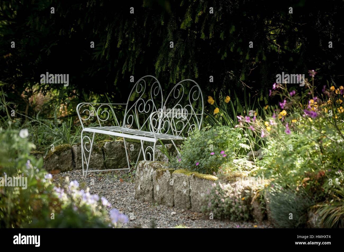 Garden seat in Garden path with flowers in early Summer, Altamont