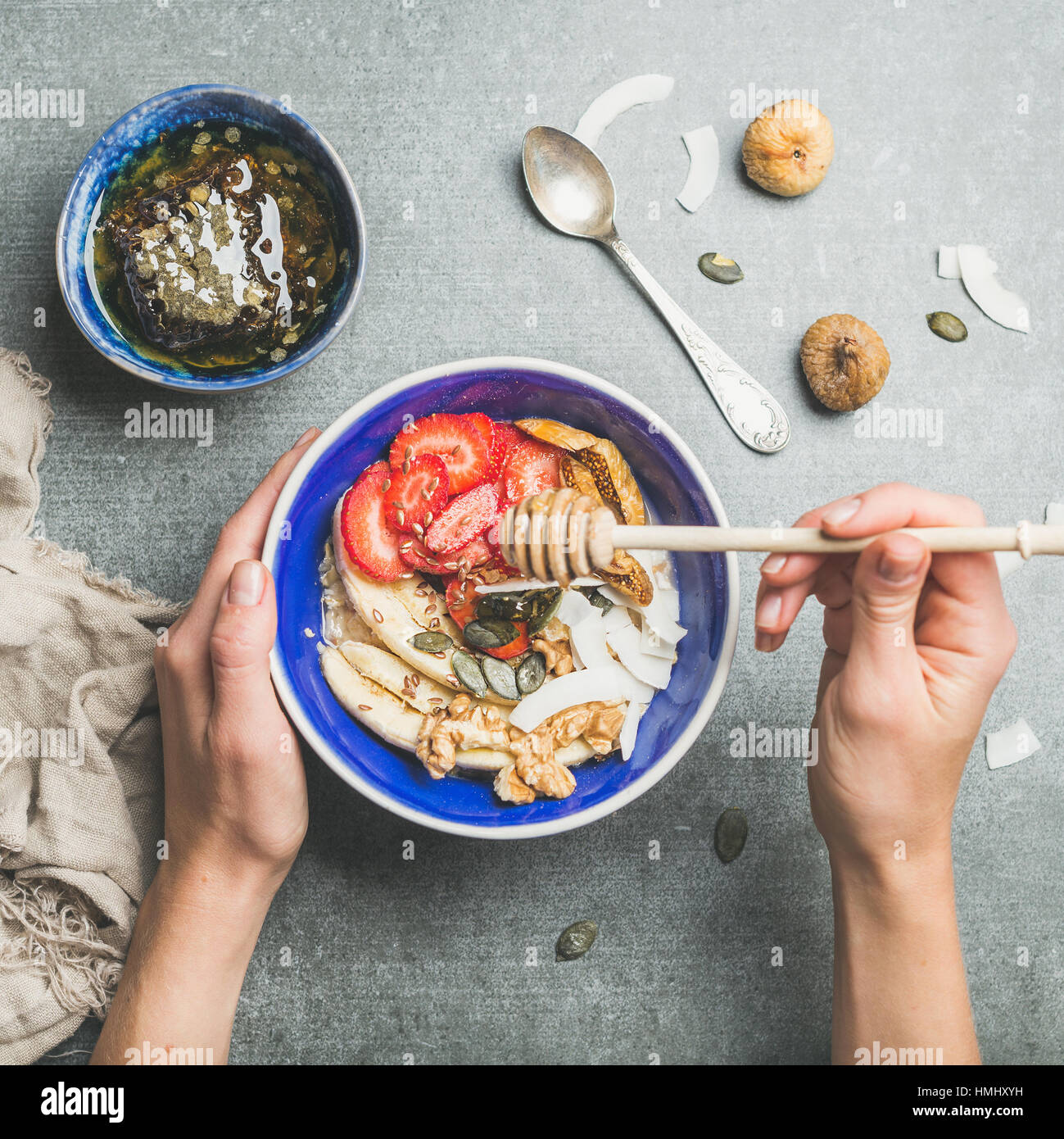 Blue bowl with healthy vegetarian breakfast in woman's hands Stock Photo