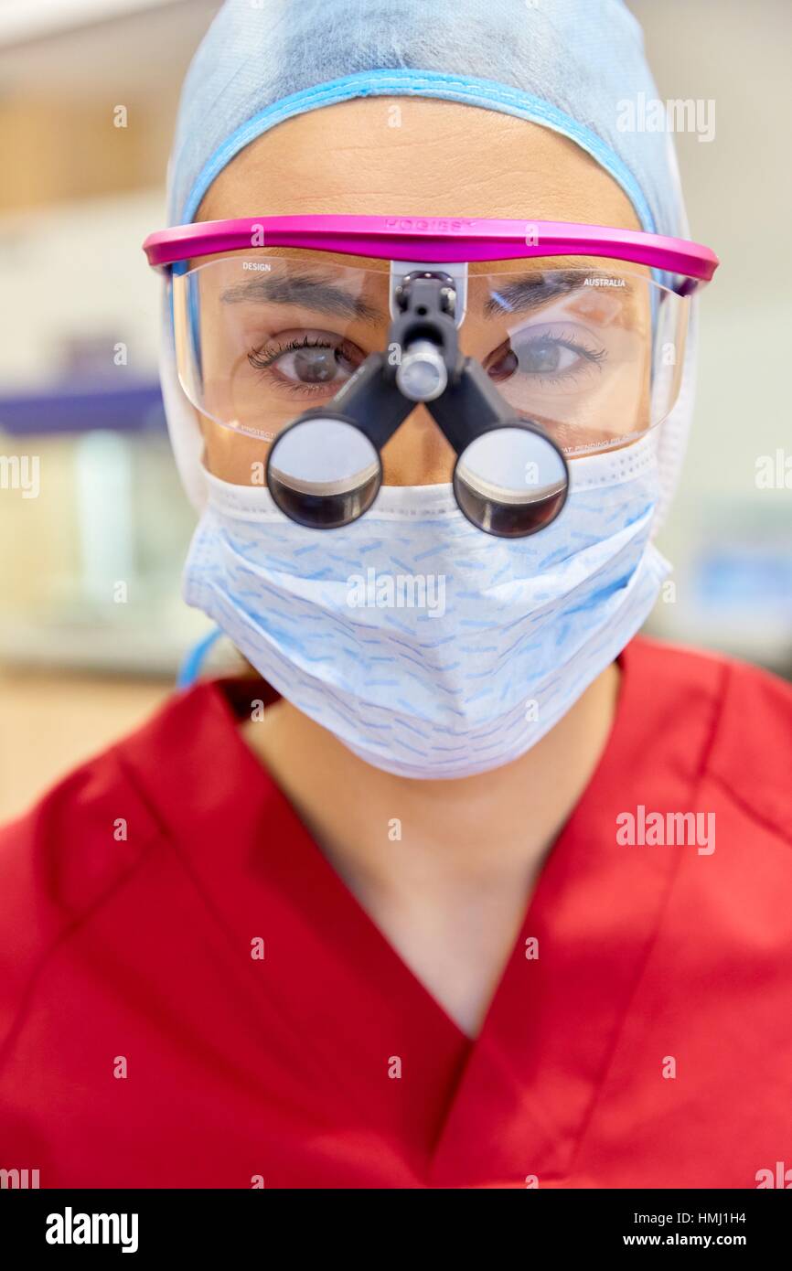 Surgeon with magnifying glasses. Surgical glasses. Plastic surgery