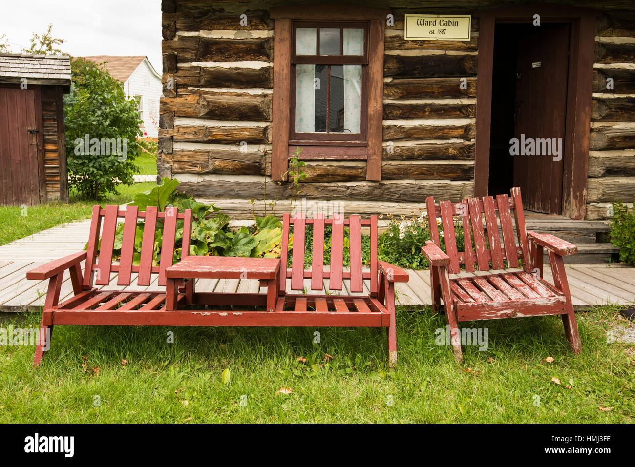 Log Cabin And Chairs At Kootenai Brown Pioneer Village Museum In