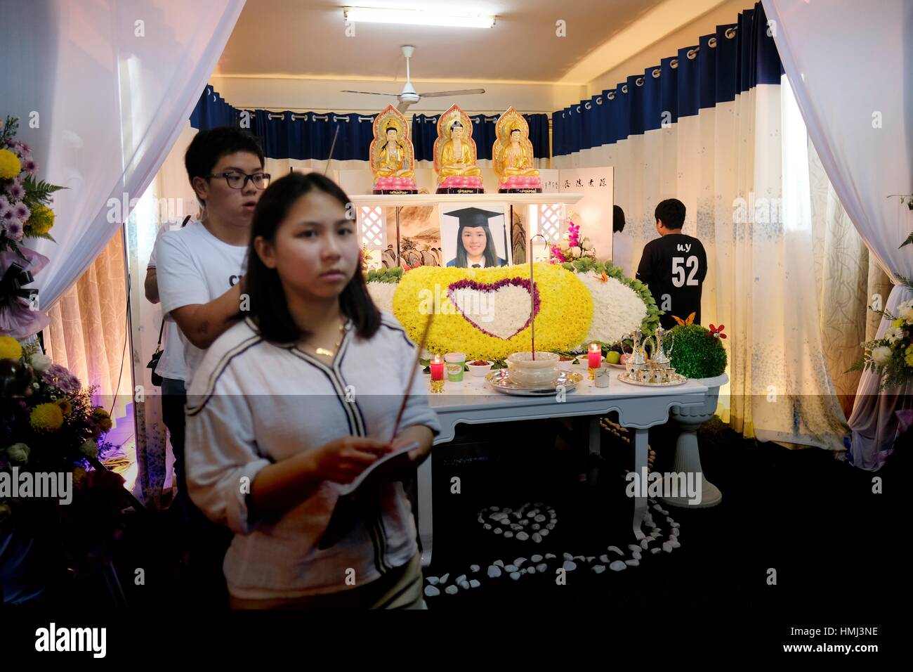 Relatives strolling in circle and prayers for the deceased. Sarawakian chinese funeral ceremony