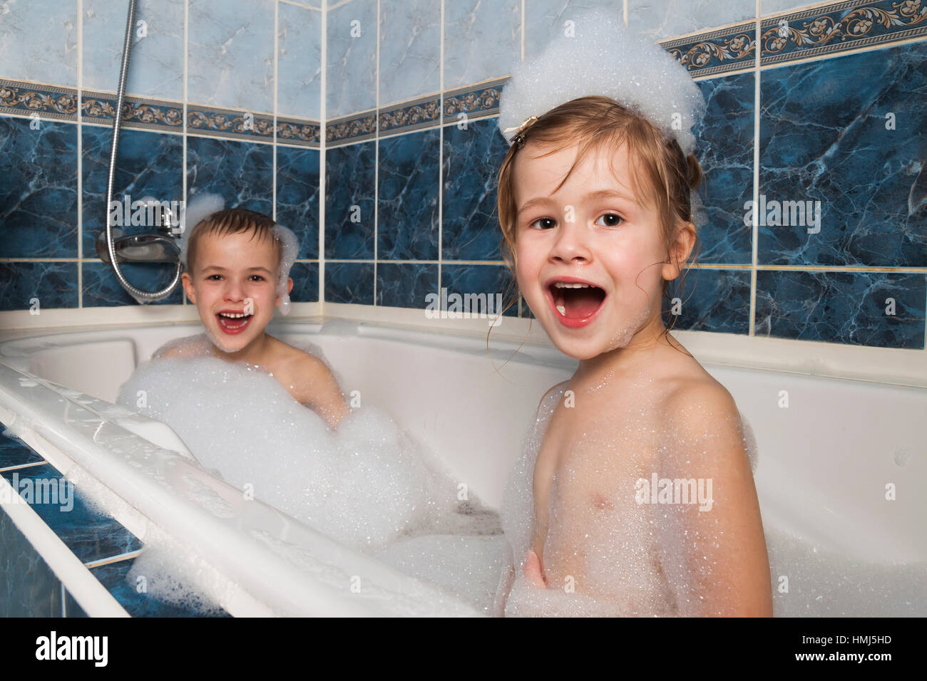 Sister Washes His Inferior Brother Brother and sister taking a bubble bath. Little boy and girl playing