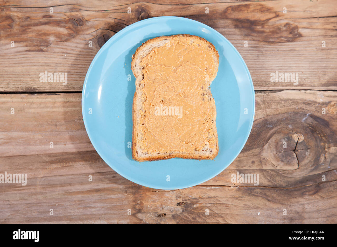 Bread with peanut butter on wooden background Stock Photo