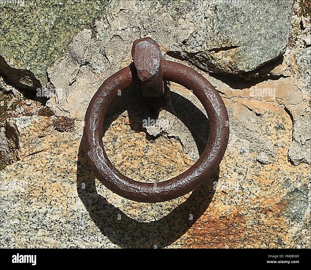 An old rusty iron ring used to tie up horses still remains embeded in