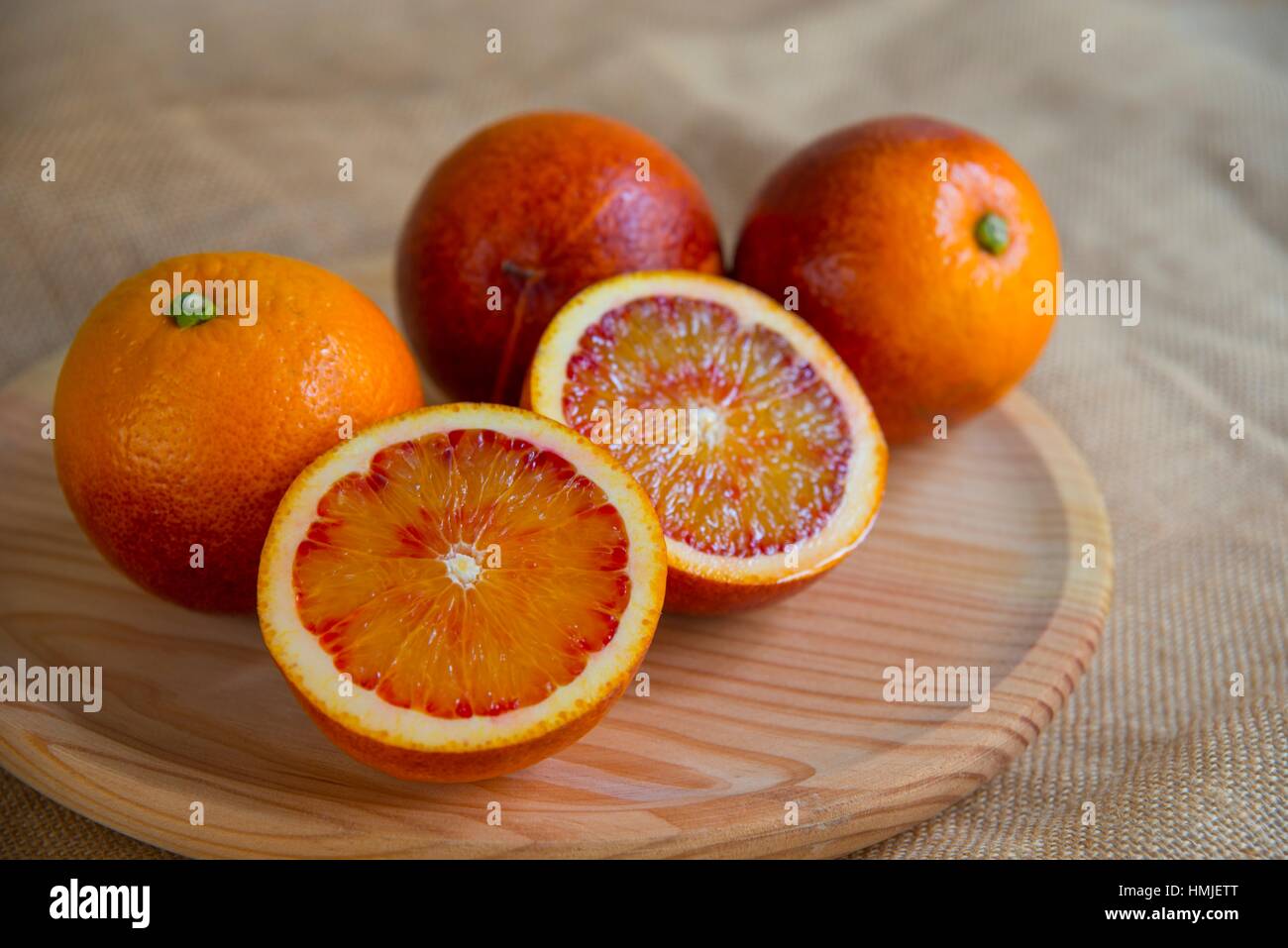 four-blood-oranges-one-of-them-cut-in-two-halves-still-life-stock
