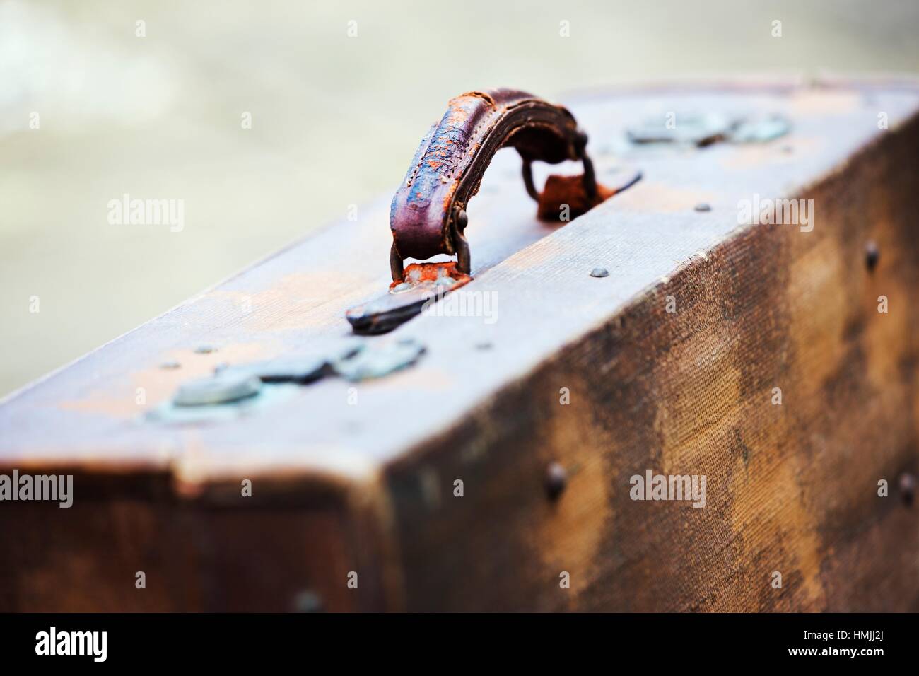 Vintage suitcase showing worn leather handle Stock Photo Alamy